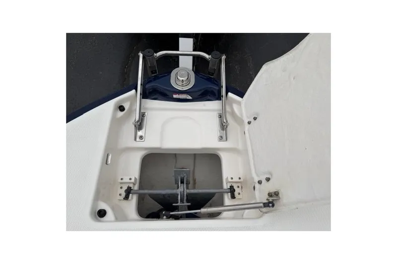Slide: The Image of 2010 Chaparral Sunesta 244 boat anchor compartment with open hatch and metal fittings. - 36