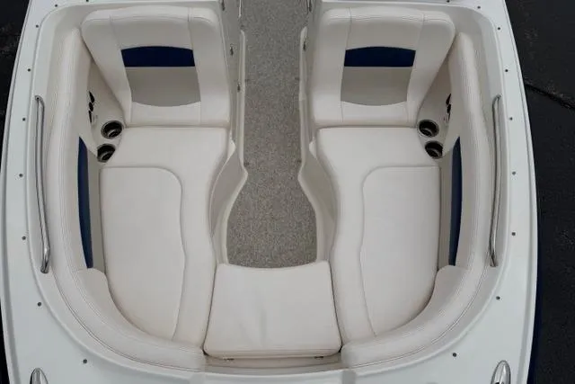 Slide: The Image of 2010 Chaparral Sunesta 244 boat interior with white seating and cup holders. - 38