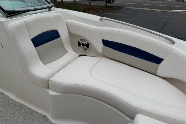 Slide: The Image of 2010 Chaparral Sunesta 244 boat interior with white and blue cushioned seating. - 39