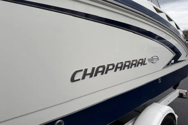 Slide: The Image of 2010 Chaparral Sunesta 244 boat side view with logo and trailer. - 4