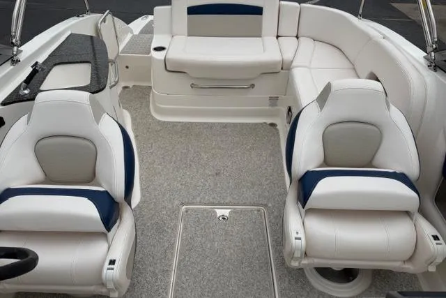 Slide: The Image of 2010 Chaparral Sunesta 244 boat interior with white and blue seating arrangement. - 41