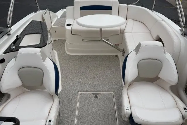 Slide: The Image of 2010 Chaparral Sunesta 244 boat interior with white seating and a central table. - 43