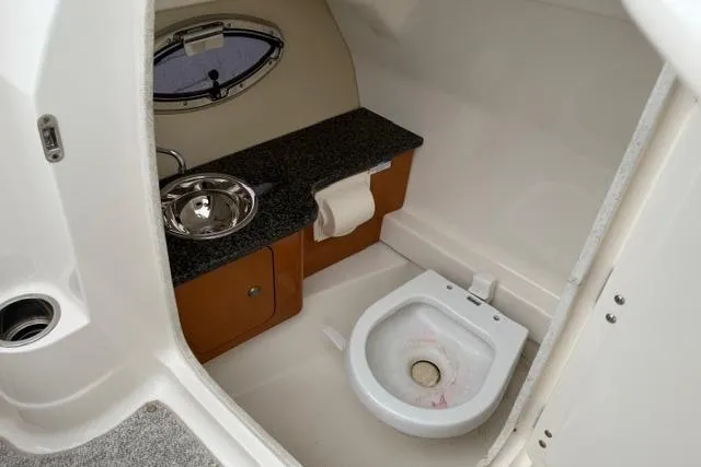 Slide: The Image of 2010 Chaparral Sunesta 244 boat interior with sink and toilet. - 46