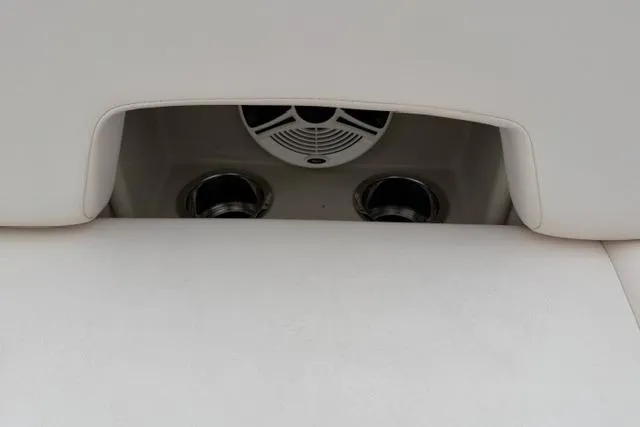 Slide: The Image of 2010 Chaparral Sunesta 244 boat interior with speaker and cup holders. - 49
