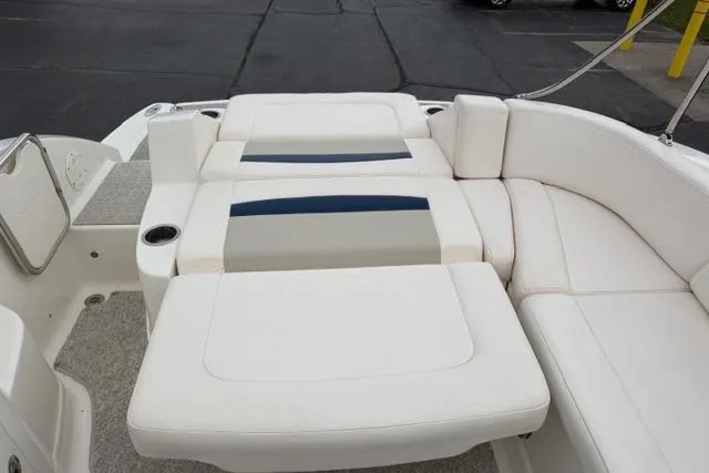 Slide: The Image of 2010 Chaparral Sunesta 244 boat interior with white cushioned seating and cup holder. - 51