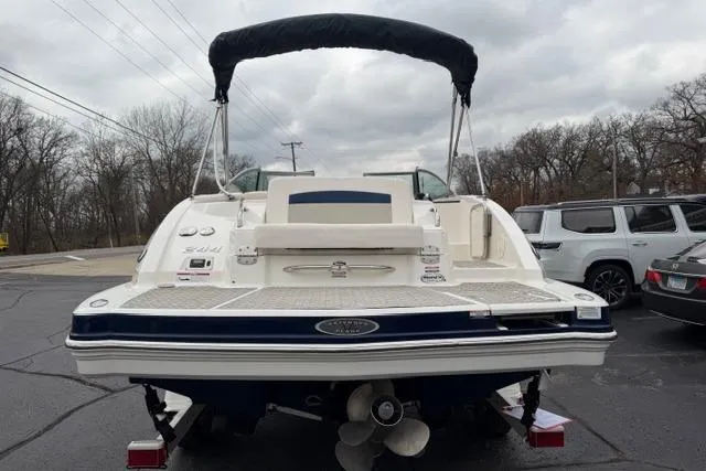 Slide: The Image of 2010 Chaparral Sunesta 244 boat with canopy, parked on a cloudy day. - 6