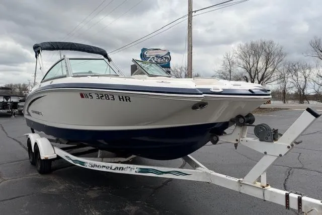 Slide: The Image of 2010 Chaparral Sunesta 244 boat on trailer, parked outdoors on a cloudy day. - 9