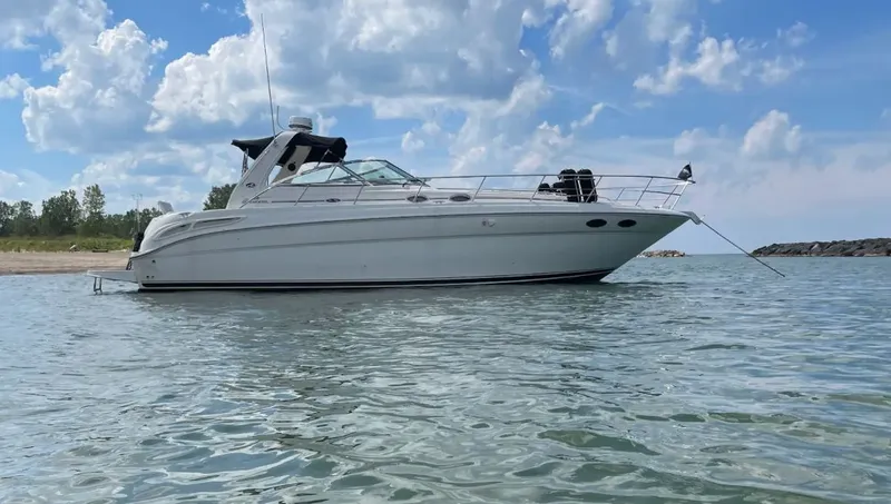 Slide: The Image of 2001 Sea Ray 380 Sundancer anchored on calm waters. - 2