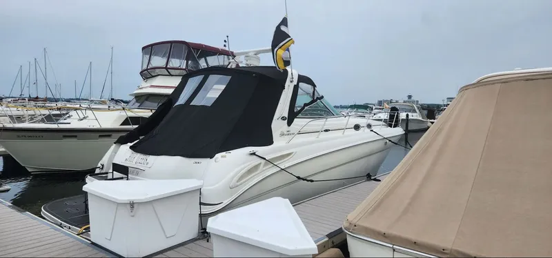 Slide: The Image of 2001 Sea Ray 380 Sundancer docked with black cover. - 4