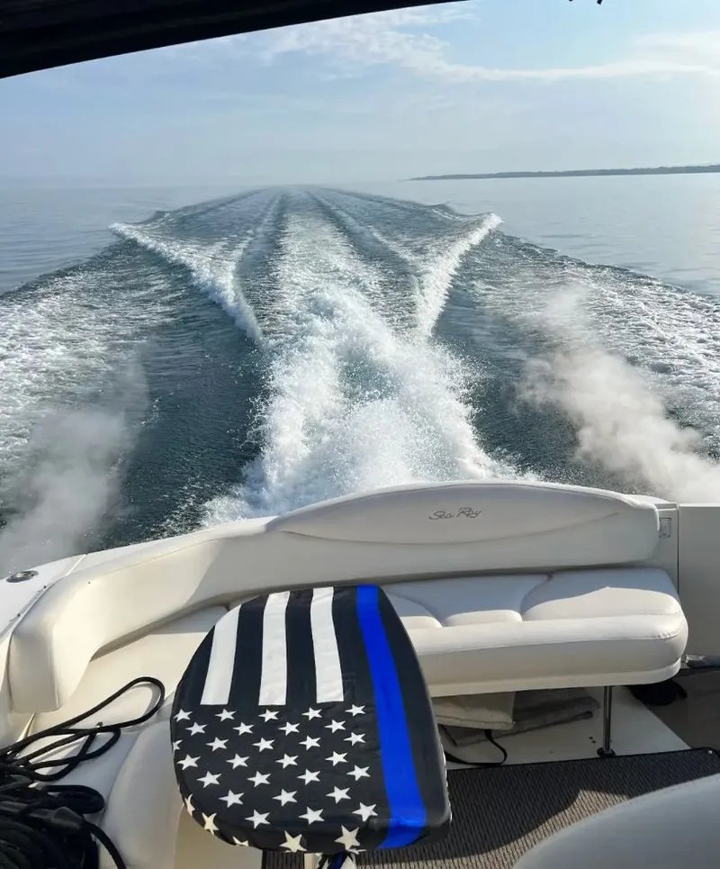 Slide: The Image of Sea Ray 380 Sundancer 2001 on calm waters with American flag design. - 6