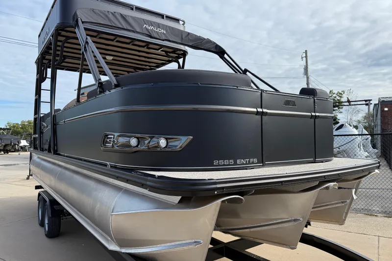 Slide: The Image of 2026 Avalon Catalina Entertainer Funship pontoon boat on trailer, sleek design, outdoor setting. - 3