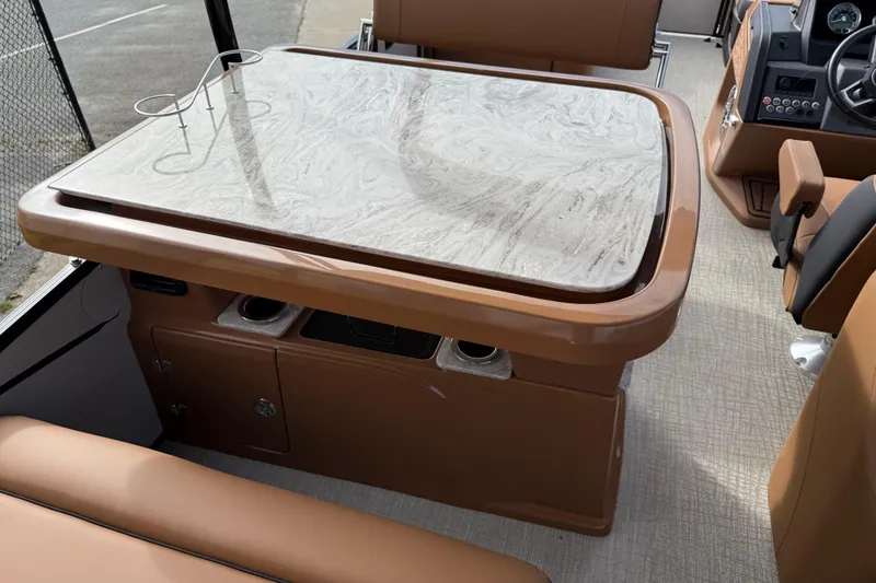 Slide: The Image of 2026 Avalon Catalina Entertainer Funship interior with marble-style table and brown seating. - 33