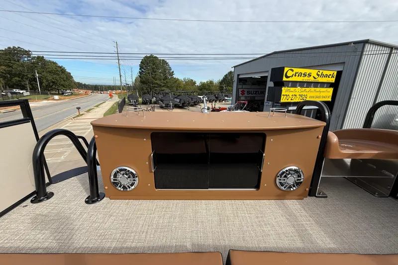 Slide: The Image of 2026 Avalon Catalina Entertainer Funship with outdoor bar setup and speakers, parked near dealership. - 50