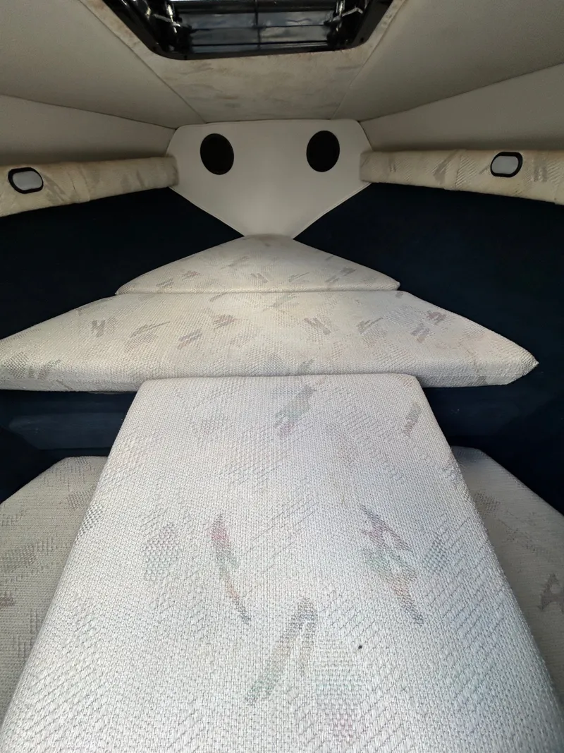 Slide: The Image of Interior of a 1993 Mariah MX20 C boat with cushioned seating. - 13