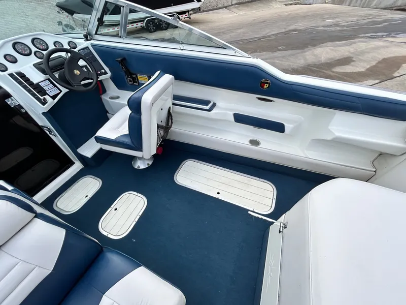 Slide: The Image of Interior of a 1993 Mariah MX20 C boat with blue and white seating. - 16