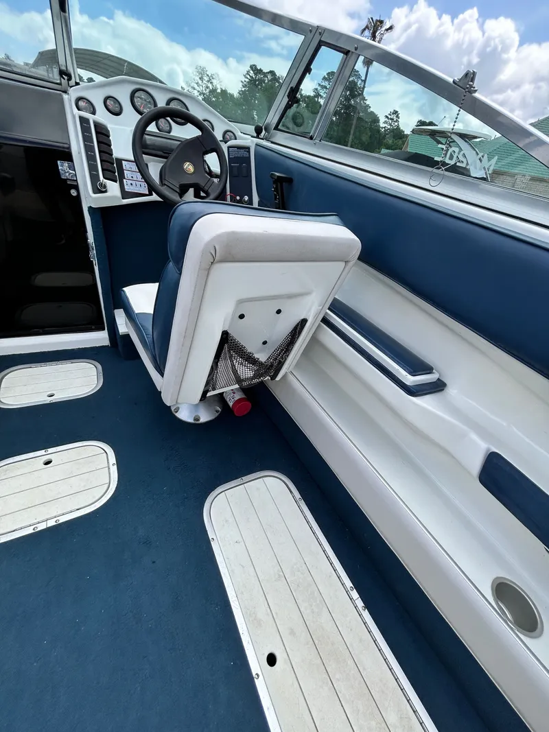 Slide: The Image of Interior of a 1993 Mariah MX20 C boat with blue seating. - 17