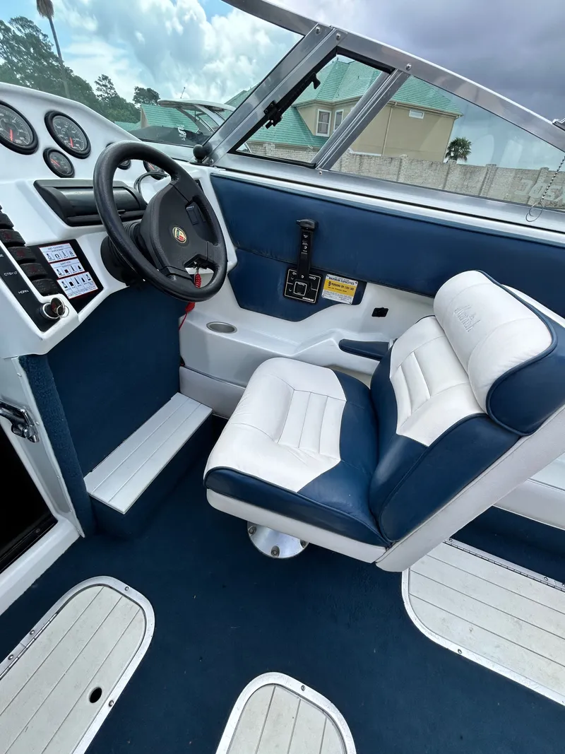 Slide: The Image of Interior of a 1993 Mariah MX20 C boat with blue and white seating. - 20