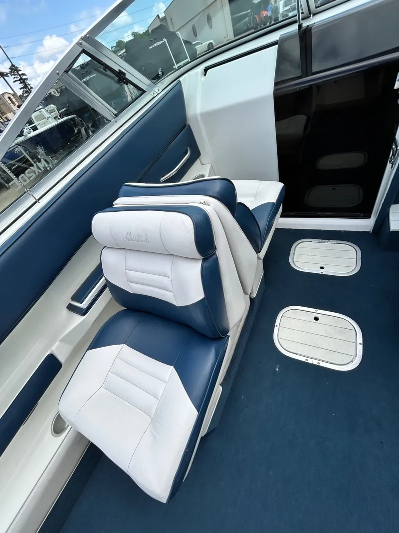 Slide: The Image of Interior of a 1993 Mariah MX20 C boat with blue and white seats. - 21