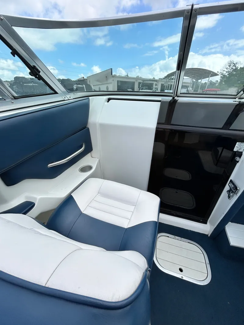 Slide: The Image of Interior of a 1993 Mariah MX20 C boat with blue and white seating. - 22