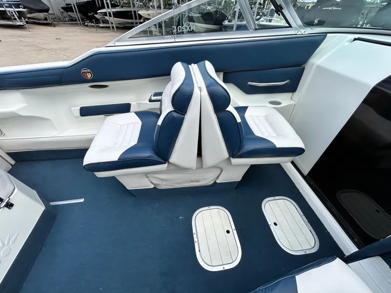 Slide: The Image of Interior of a 1993 Mariah MX20 C boat with blue and white seating. - 23