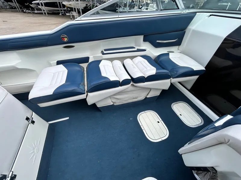 Slide: The Image of Interior of a 1993 Mariah MX20 C boat with blue and white seating. - 24