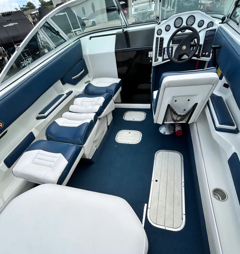 Slide: The Image of Interior of a 1993 Mariah MX20 C boat with blue seating. - 25
