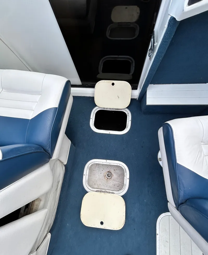 Slide: The Image of Interior of a 1993 Mariah MX20 C boat with blue seating. - 26