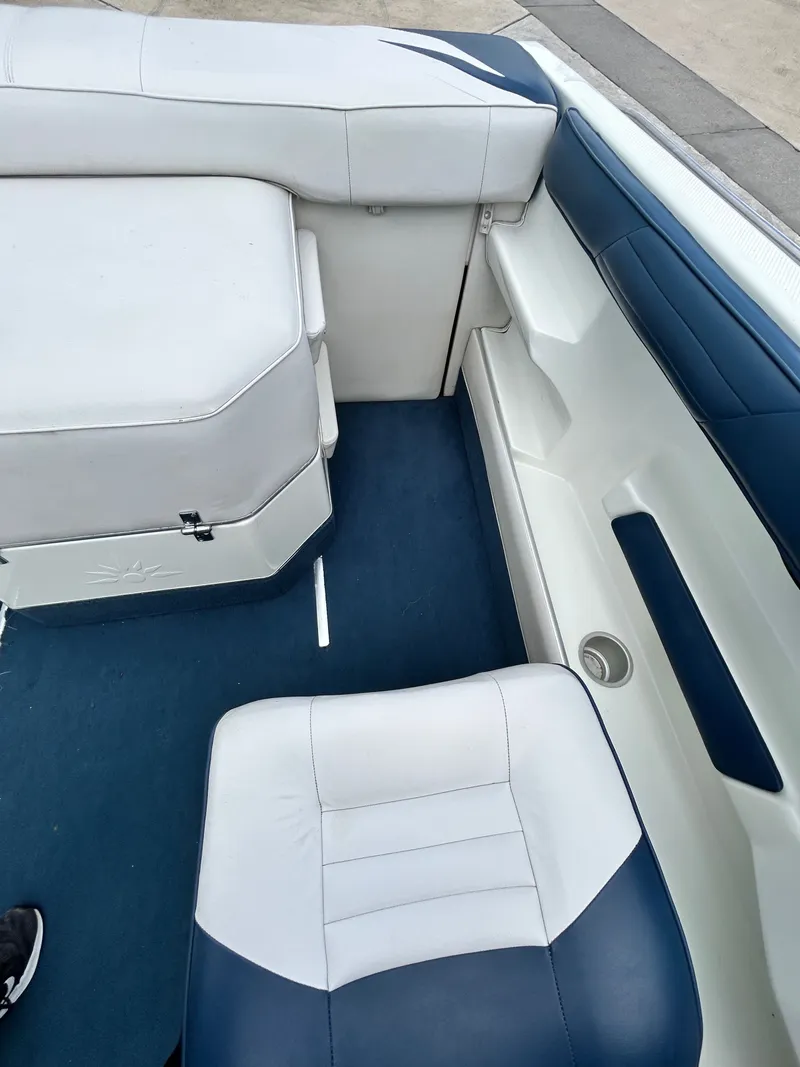 Slide: The Image of Interior of a 1993 Mariah MX20 C boat with blue and white seating. - 29