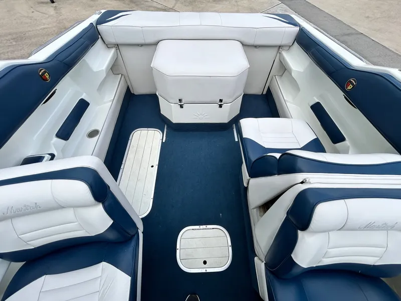 Slide: The Image of Interior of a 1993 Mariah MX20 C boat with blue and white seating. - 32