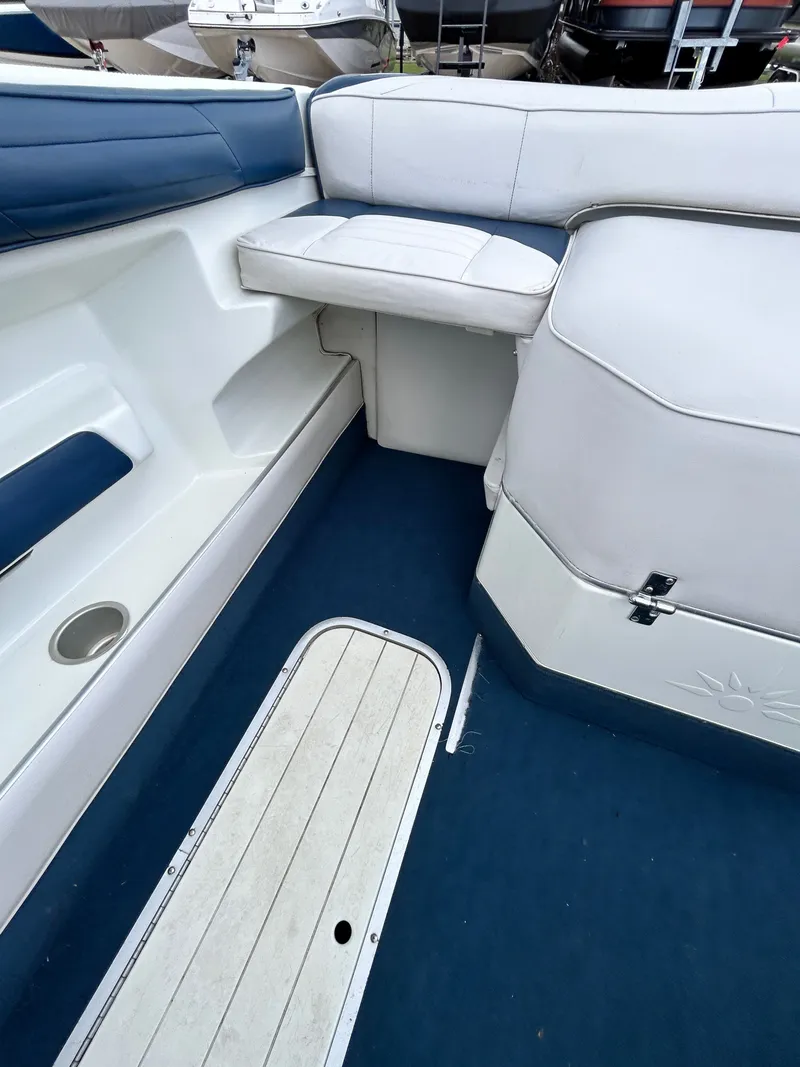 Slide: The Image of Interior of a 1993 Mariah MX20 C boat with blue and white seating. - 37