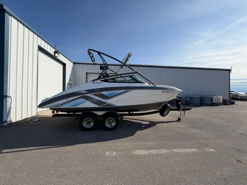The Image of 2015 Yamaha 212X boat on trailer outside warehouse. - 0