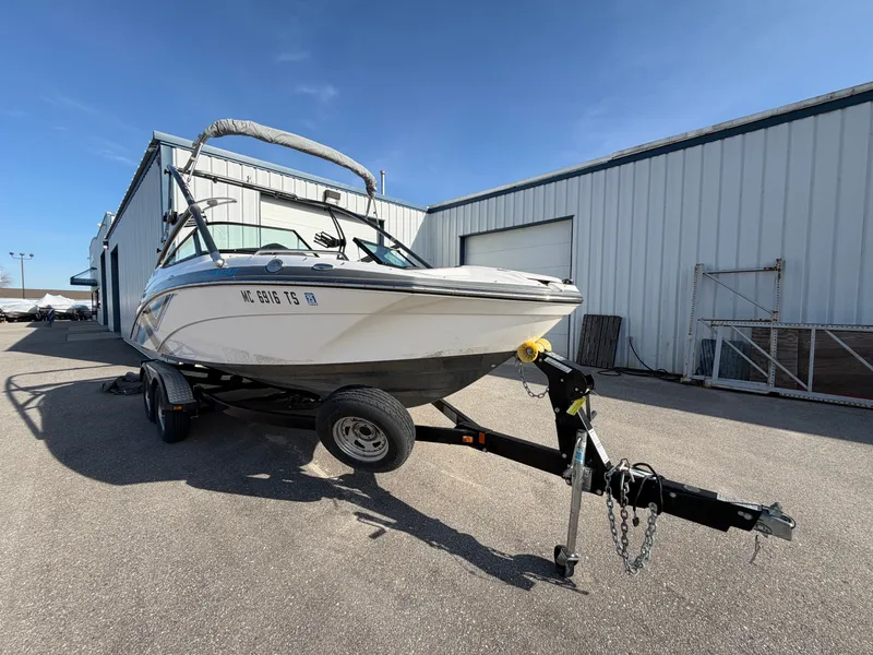 Slide: The Image of 2015 Yamaha Boats 212X on trailer outside warehouse. - 1