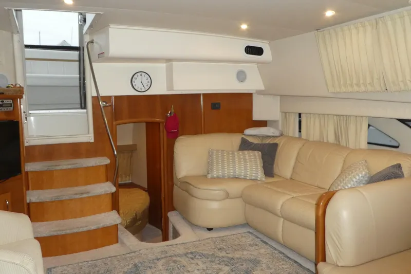 Slide: The Image of Luxurious interior of 2006 Carver 366 Motor Yacht with beige leather seating and wooden accents. - 15