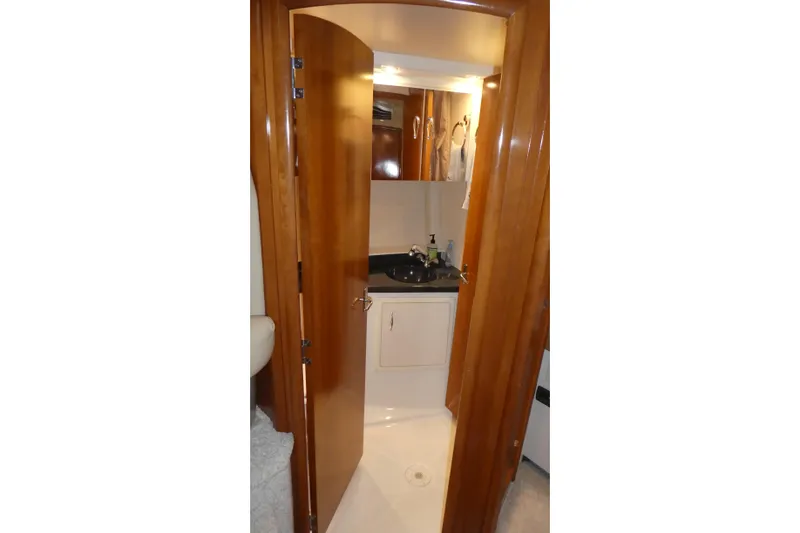 Slide: The Image of 2006 Carver 366 Motor Yacht bathroom with wooden door and modern sink. - 22