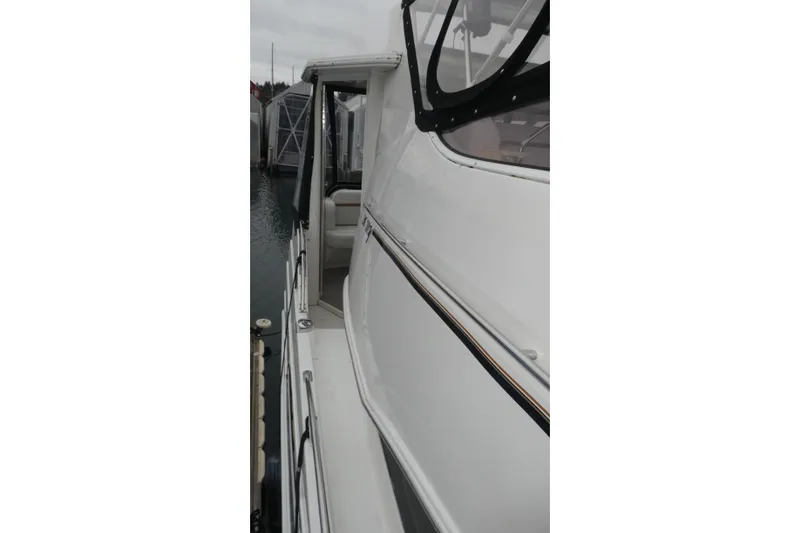 Slide: The Image of 2006 Carver 366 Motor Yacht docked, showcasing sleek white exterior and side view. - 3