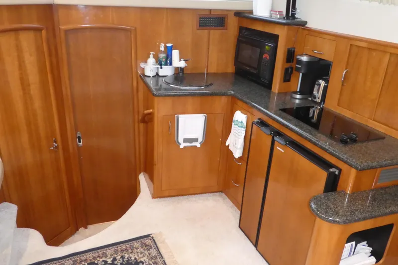 Slide: The Image of 2006 Carver 366 Motor Yacht kitchen with wood cabinetry, appliances, and granite countertops. - 39