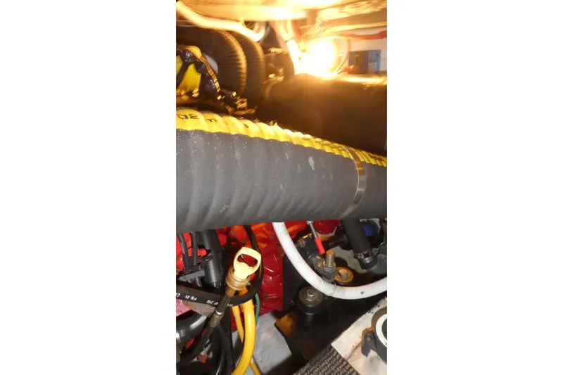 Slide: The Image of Engine room of 2006 Carver 366 Motor Yacht with visible hoses and components. - 46