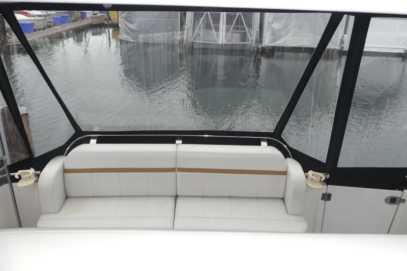 Slide: The Image of 2006 Carver 366 Motor Yacht interior with white seating and marina view. - 5