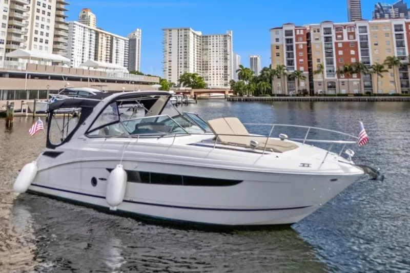 The Image of 2015 Sea Ray Sundancer 350 yacht docked in urban marina with cityscape backdrop. - 0