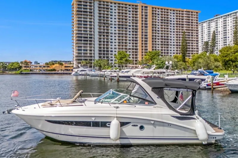 Slide: The Image of 2015 Sea Ray Sundancer 350 yacht docked near high-rise buildings. - 3