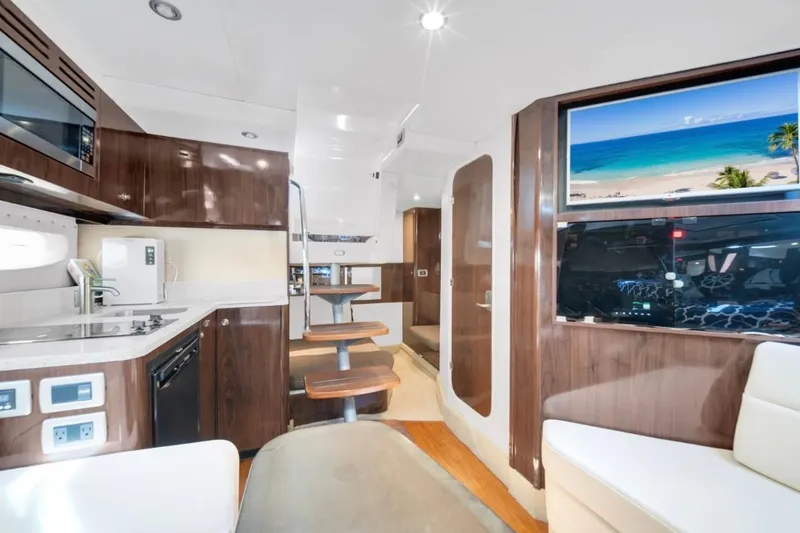 Slide: The Image of Luxurious interior of 2015 Sea Ray Sundancer 350 yacht with modern kitchen and seating area. - 9