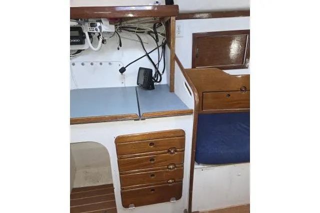 Slide: The Image of 1986 Bill Lee Yachts Santa Cruz 50 interior with navigation station and wooden cabinetry. - 18