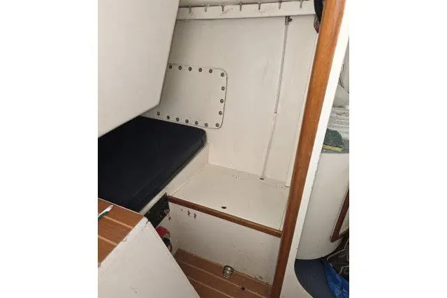 Slide: The Image of Interior cabin of 1986 Bill Lee Yachts Santa Cruz 50, featuring wooden accents and seating. - 20