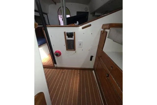 Slide: The Image of Interior of 1986 Bill Lee Yachts Santa Cruz 50 with wooden flooring and cabinetry. - 30