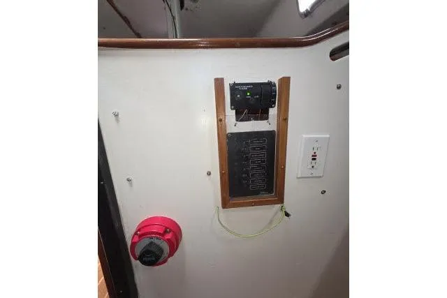 Slide: The Image of Control panel inside 1986 Bill Lee Yachts Santa Cruz 50, featuring electrical switches and wiring. - 31