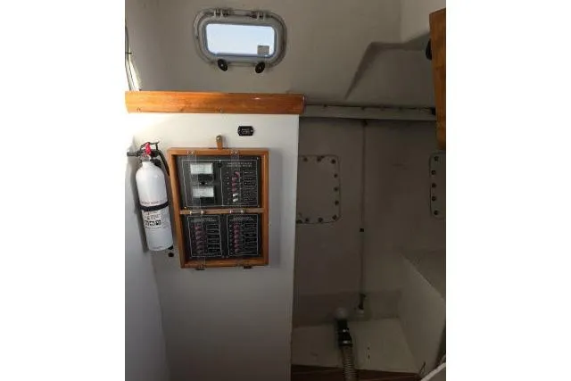 Slide: The Image of Electrical panel and fire extinguisher inside 1986 Bill Lee Yachts Santa Cruz 50 sailboat. - 33