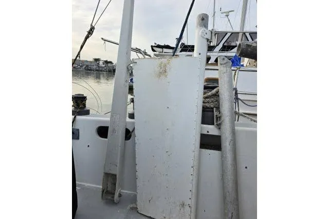 Slide: The Image of 1986 Bill Lee Yachts Santa Cruz 50 deck with sailing equipment and ropes. - 34