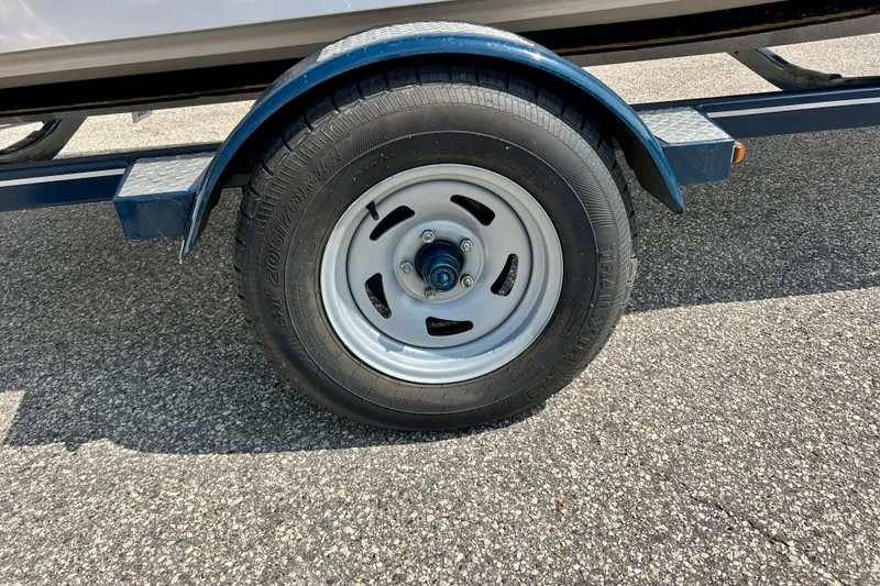 Slide: The Image of Trailer wheel of a 2017 Four Winns 180 Horizon boat on asphalt surface. - 10