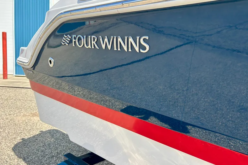 Slide: The Image of 2017 Four Winns 180 Horizon boat with blue and red detailing. - 11