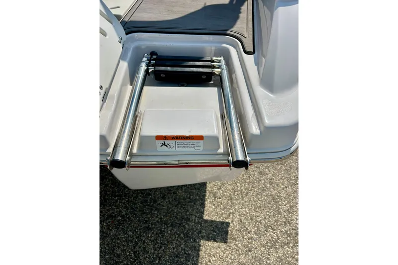 Slide: The Image of 2017 Four Winns 180 Horizon boat ladder with safety warning label. - 15